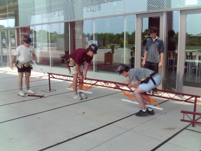 Team members practice assembly of the bridge